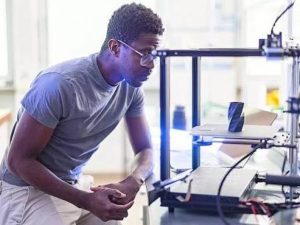 Engineer inspecting a metal 3D printing process during additive manufacturing quality control