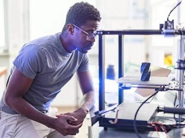 Engineer inspecting a metal 3D printing process during additive manufacturing quality control